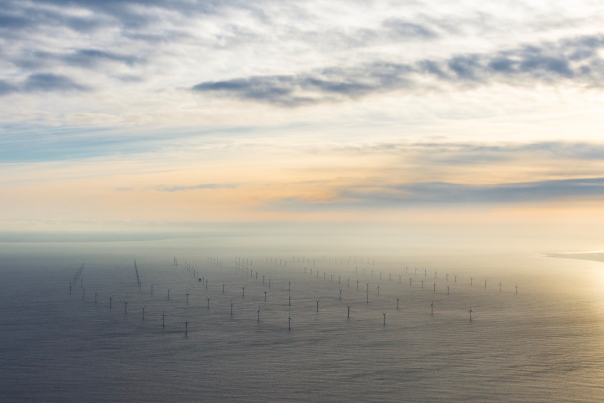 Aerial view of offshore wind farm at sunset